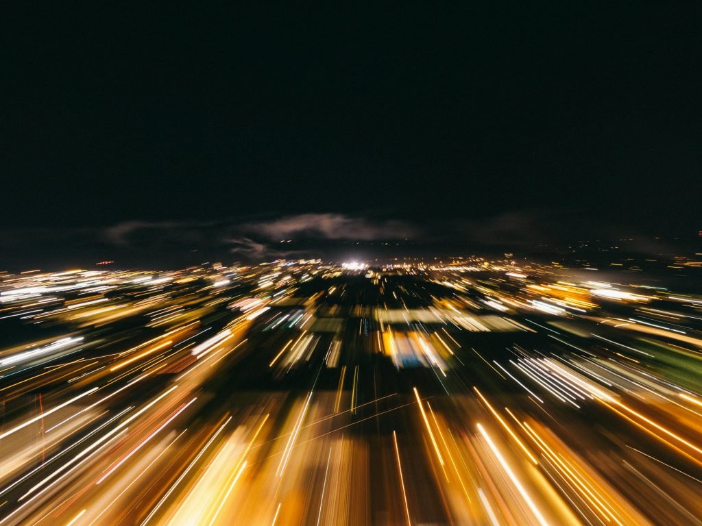 pexels-photo-2618118-2618118 Blurred city lights captured with a long exposure, creating dynamic motion effects.